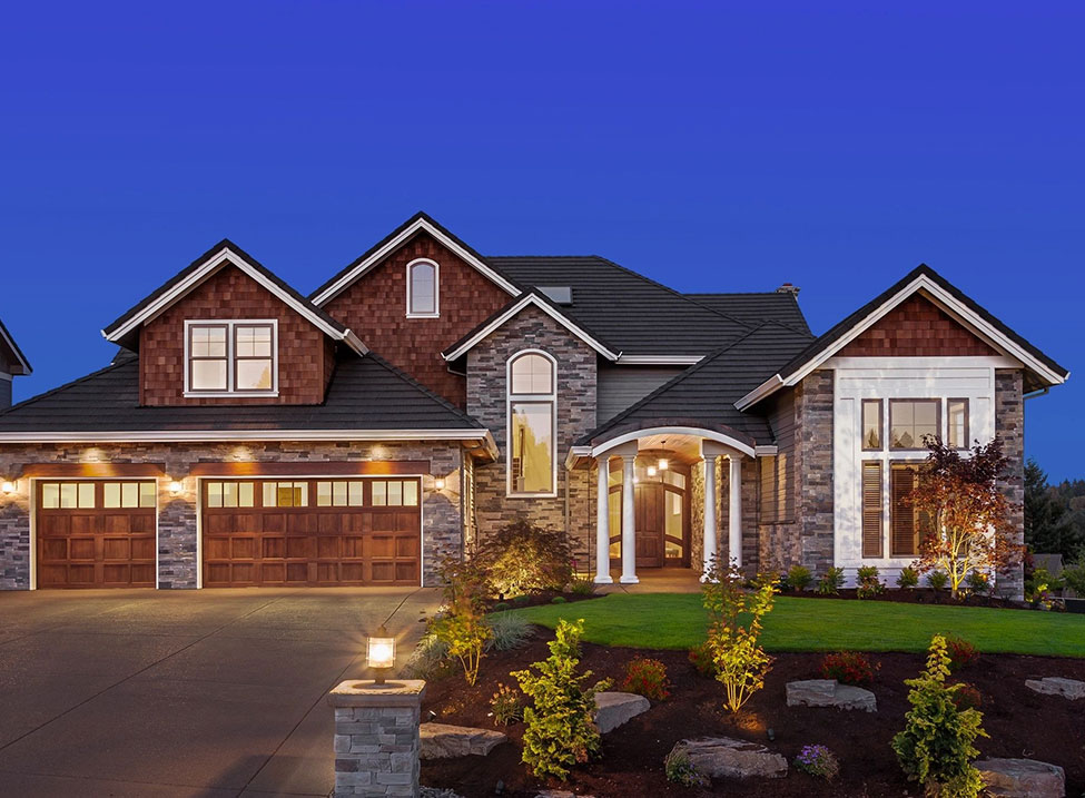 A large home with a driveway and lawn.